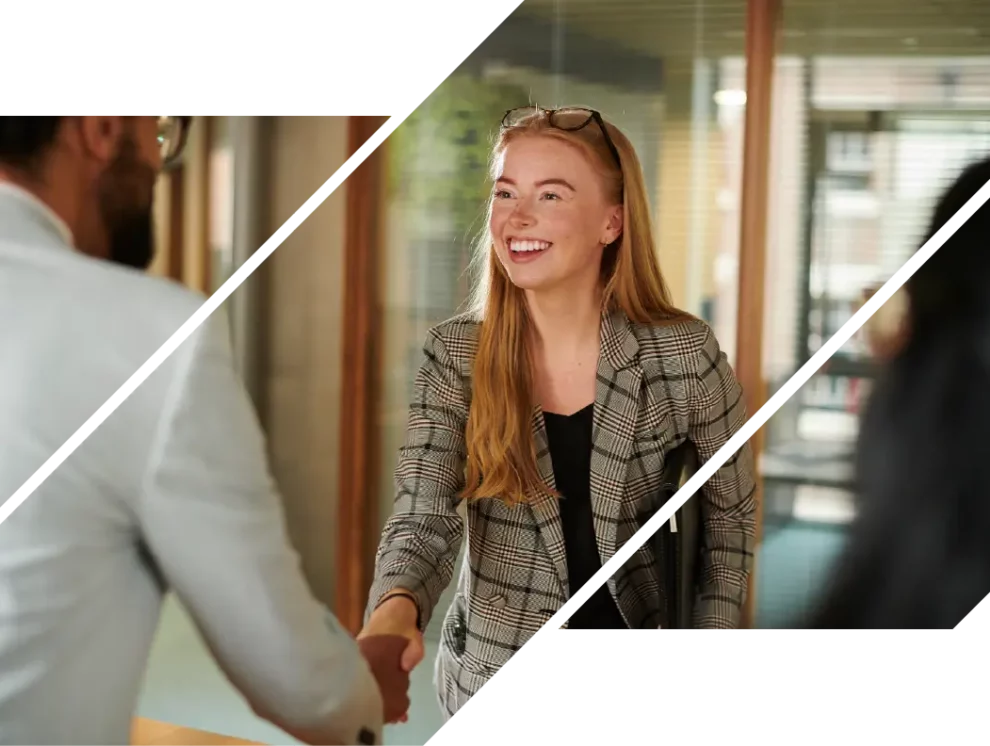 A redhead woman shaking a hiring manager's hand after applying at ICCU.