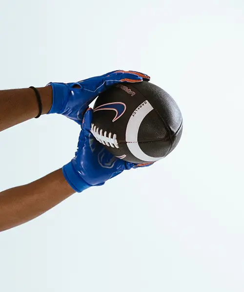 Close-up of football being caught by athlete’s hands – Boise State Football