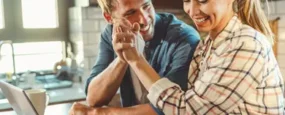 Couple giving a high five in the kitchen