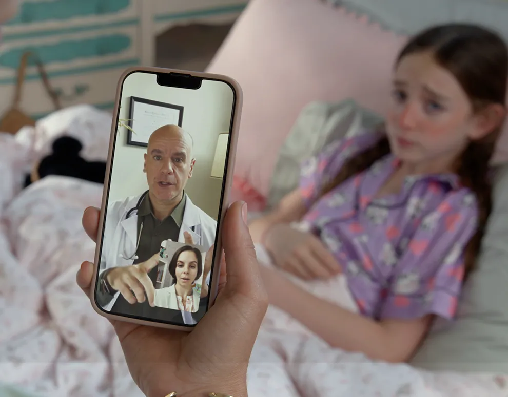 A cell phone video call with a doctor and a sick kid in bed