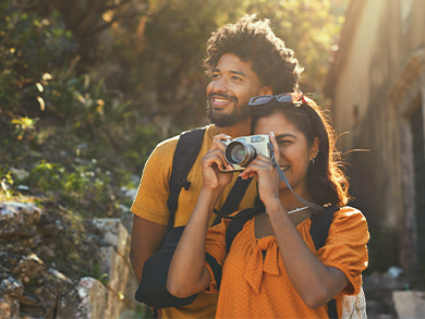 A couple enjoying the outdoors and taking a photograph.