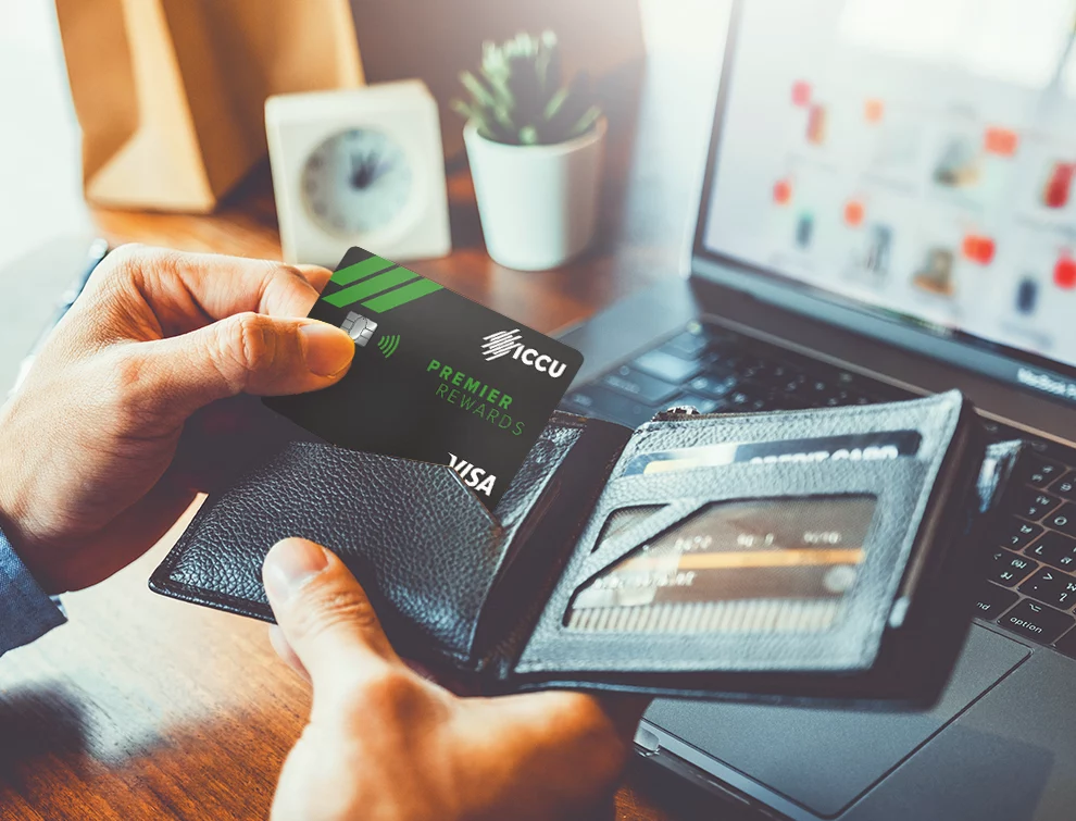 Man holding wallet and ICCU Credit Card