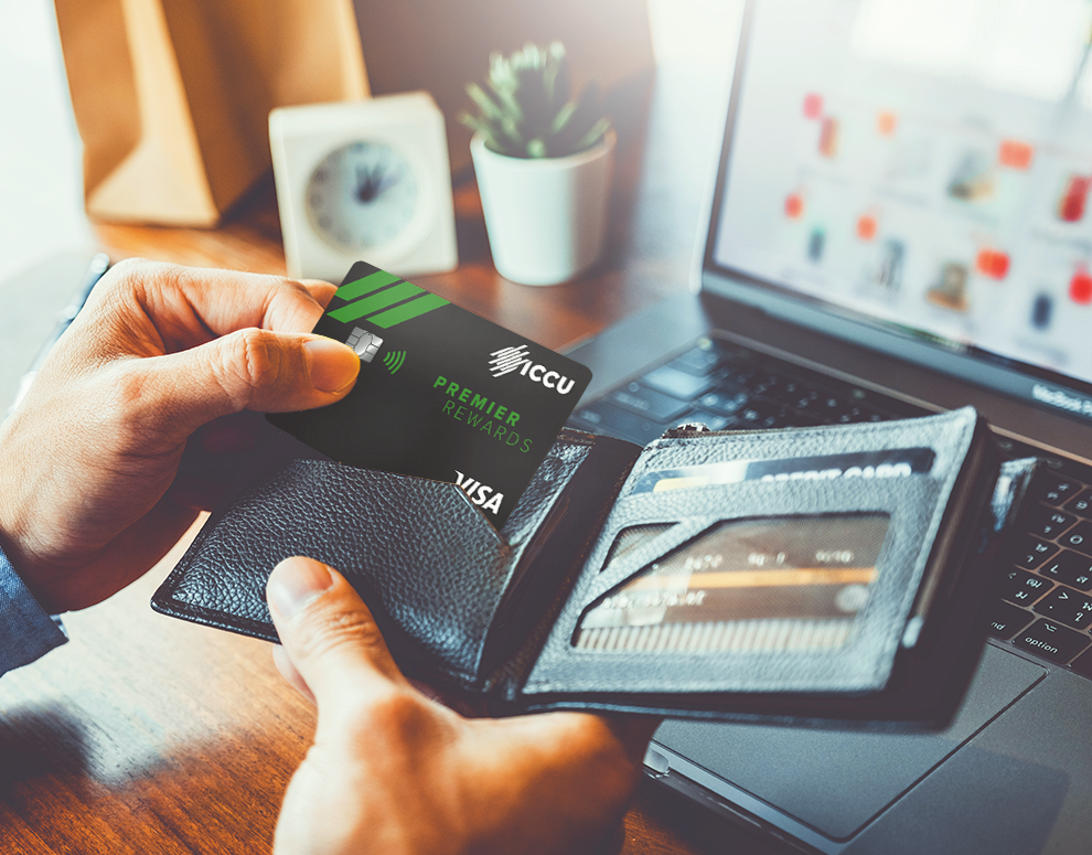 Man holding wallet and ICCU Credit Card