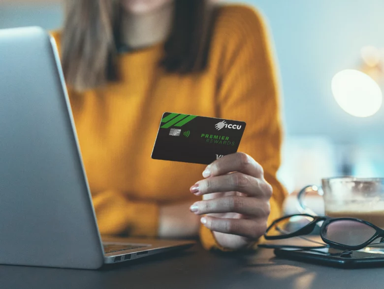 women holding her ICCU credit card